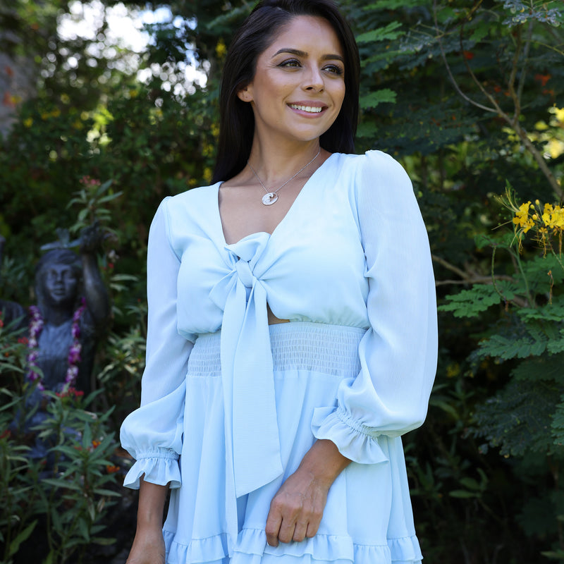 woman with blue dress wearing Nalu Pendant in White Gold with Diamonds - 26mm in Hawaiian botanical garden