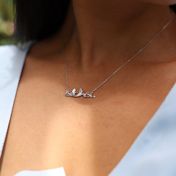 Close up of woman wearing Aloha Necklace in White Gold with Diamonds 