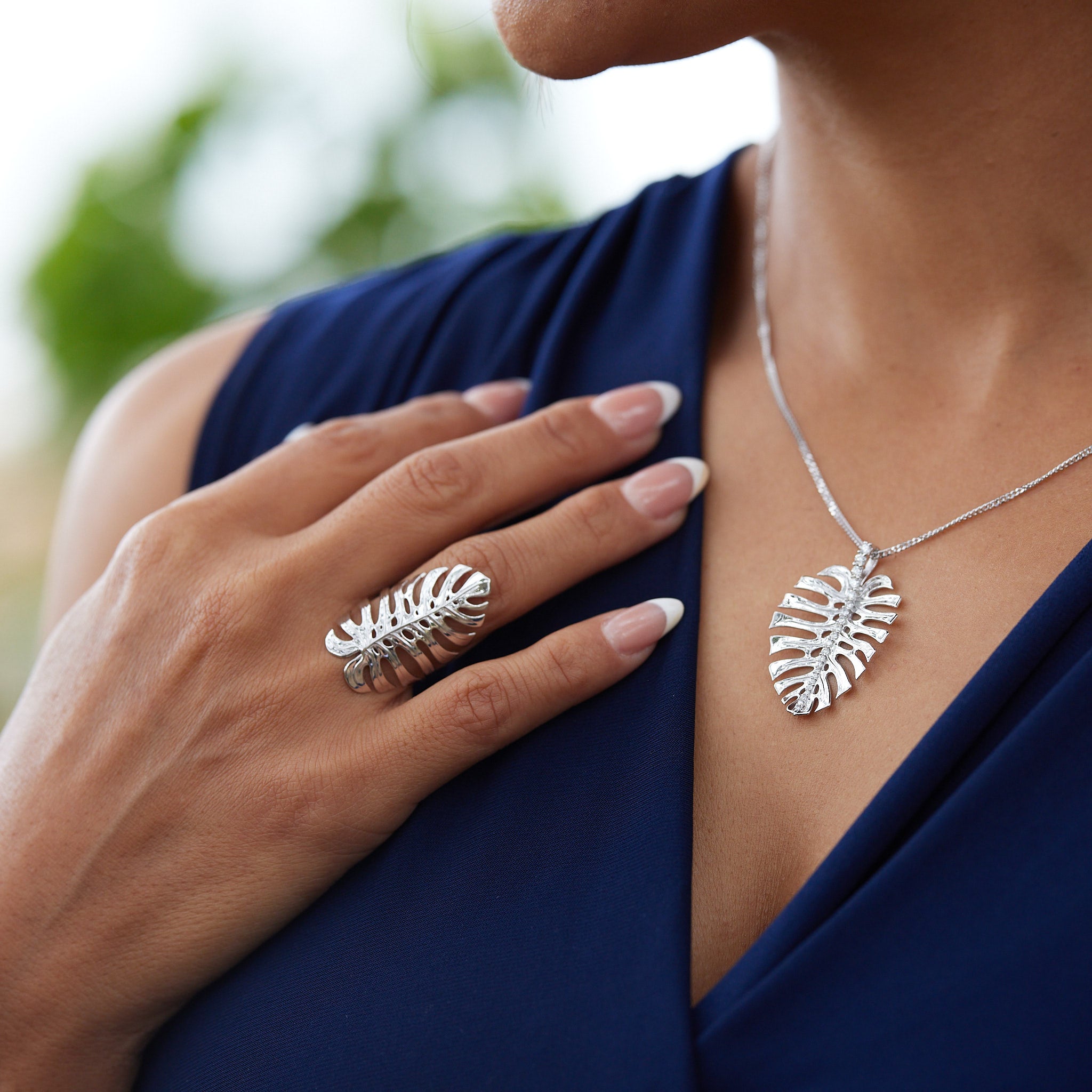 A woman wearing a Monstera Ring in White Gold and a necklace - Maui Divers Jewelry