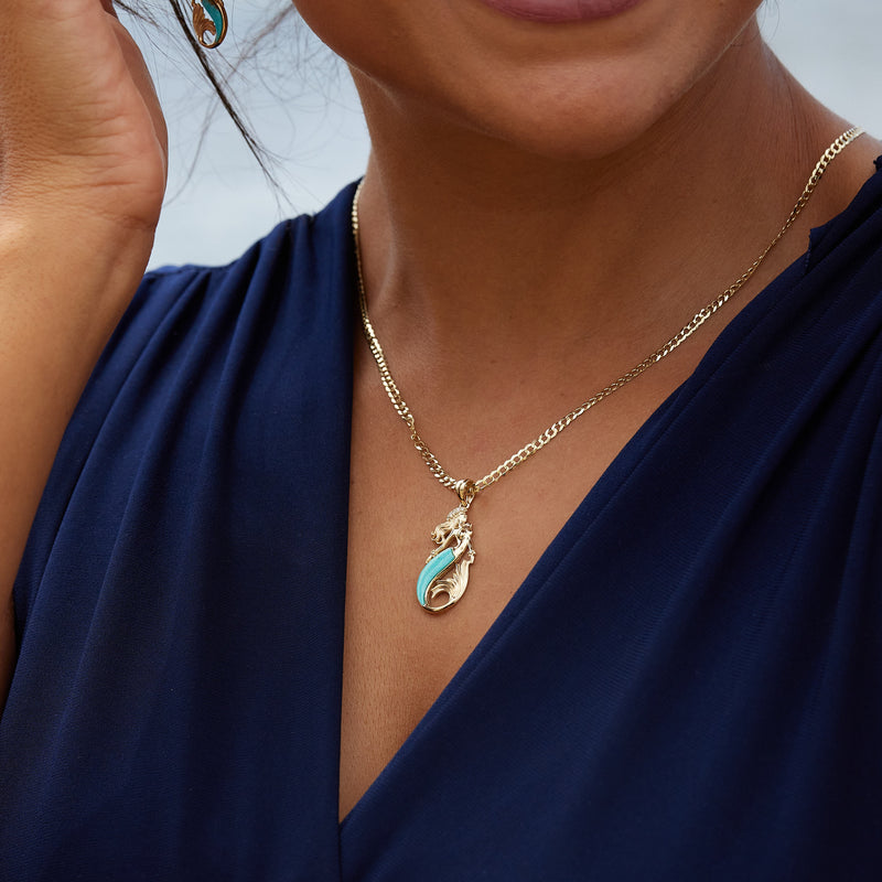 A woman's chest with a Sealife Mermaid Turquoise Pendant in Gold with Diamonds - 30mm - Maui Divers Jewelry 
