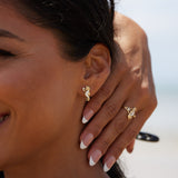 A woman wearing Sealife Seahorse Mother of Pearl Earrings in Gold with Diamonds - 15mm - Maui Divers Jewelry