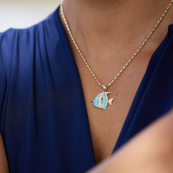 A womanʻs chest with a Sealife Angelfish Turquoise Pendant in Gold with Diamonds -23mm - Maui Divers Jewelry