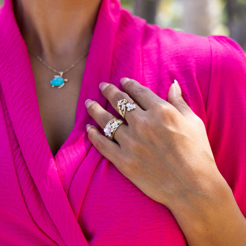 A woman wearing a Hawaiian Gardens Hibiscus Ring in Multi Color Gold with Diamonds - 12mm - Maui Divers Jewelry