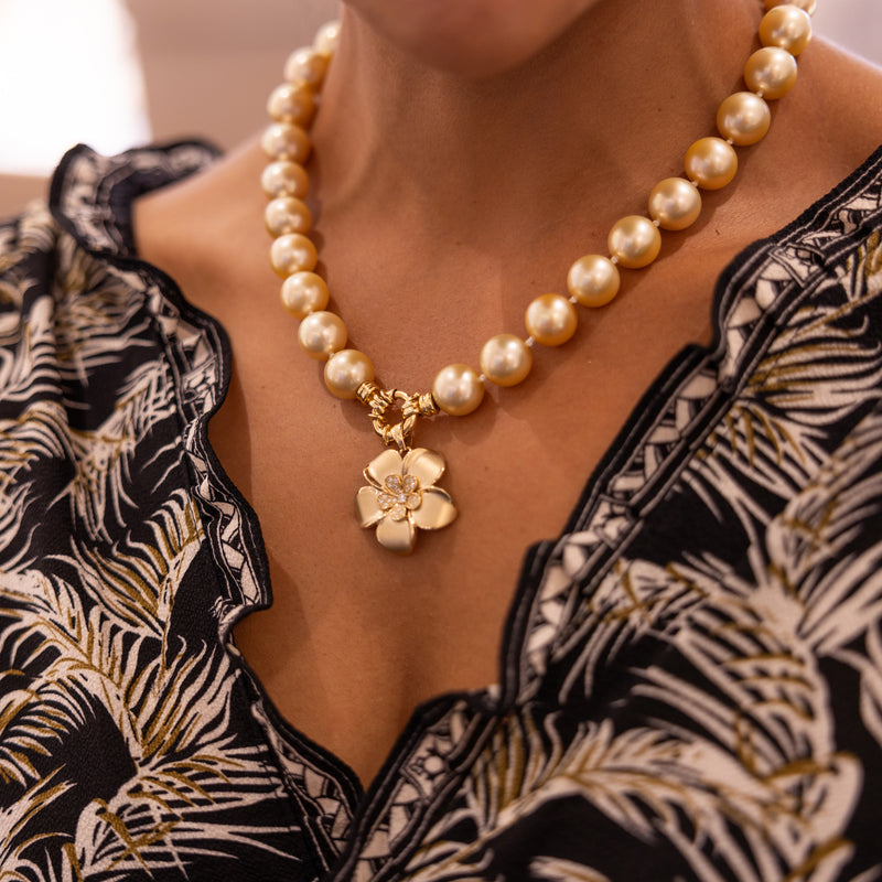 A woman wearing a Plumeria Pendant in Gold with Diamonds - 28mm-Maui Divers Jewelry