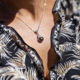 A woman's chest with a Living Heirloom Tahitian Black Pearl Pendant in White Gold with Diamonds - 9-10mm - Maui Divers Jewelry