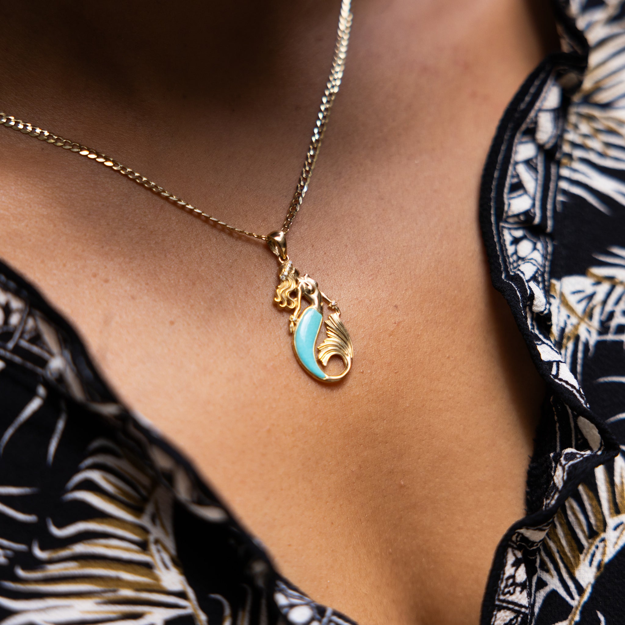 A woman's chest with a Sealife MErmaid Turquoise Pendant in Gold with Diamonds - 30mm - Maui Divers Jewelry
