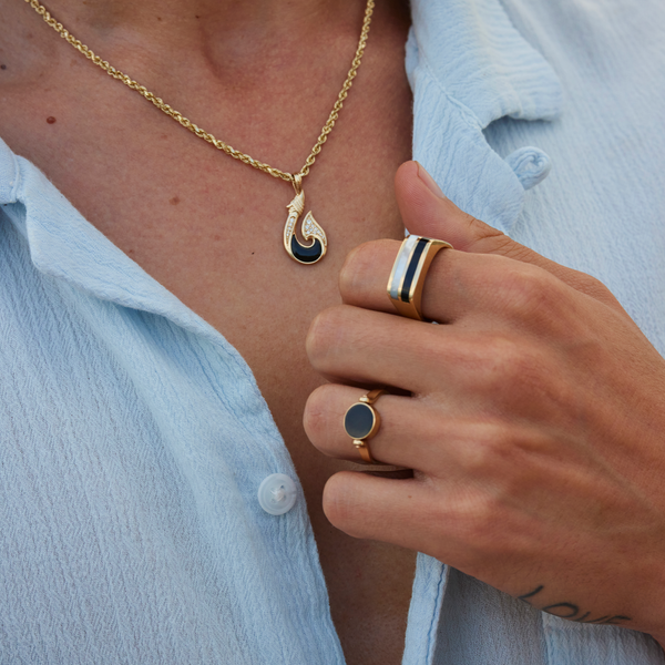 Man wearing eclipse flipside black coral and mother of pearl ring