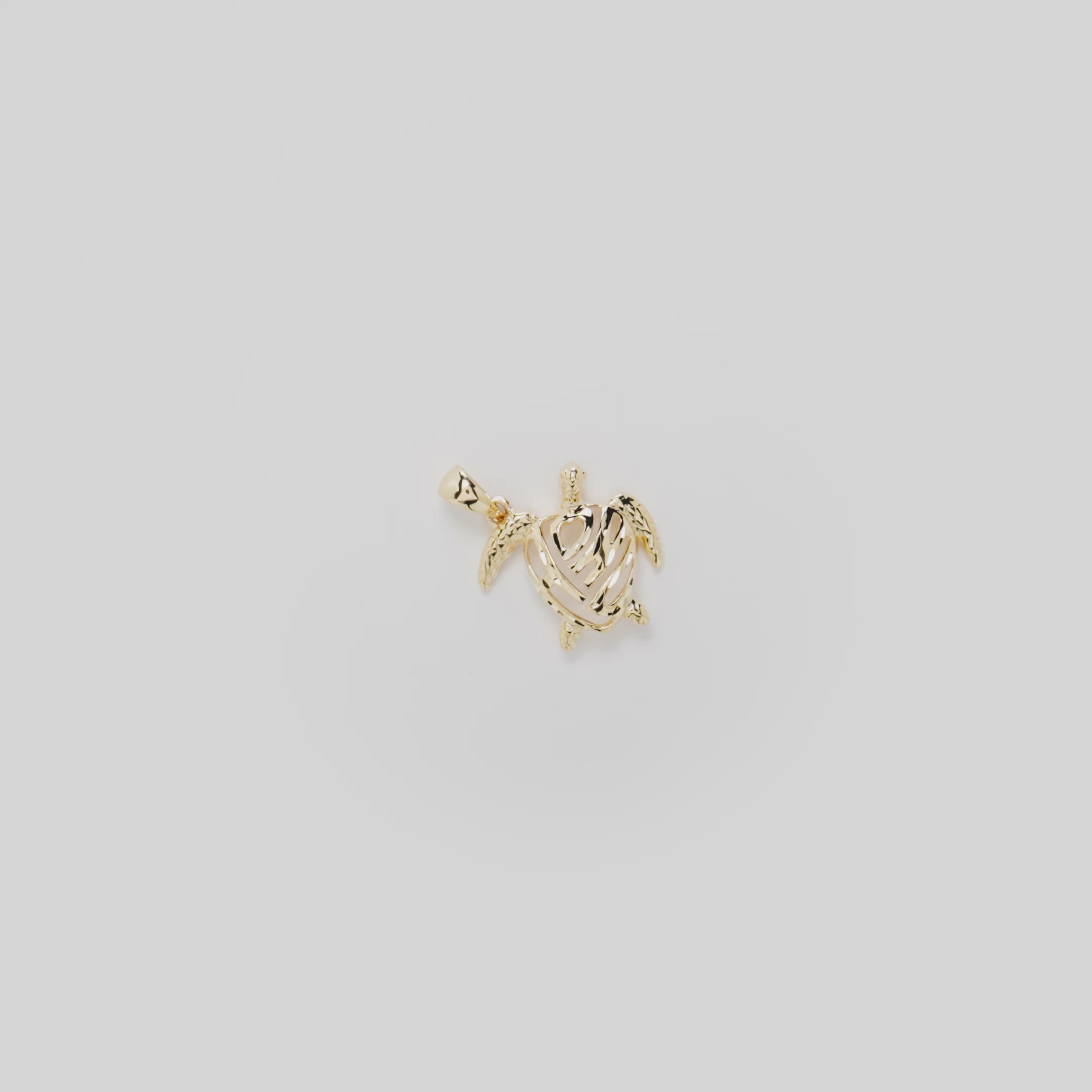 Video showcasing the 15mm Honu Pendant in 14k Yellow Gold on a White Background
