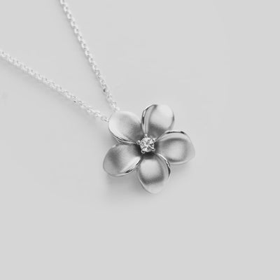 Video of the 24" Adjustable Plumeria White Sapphire Necklace in Sterling Silver  turning on a white background