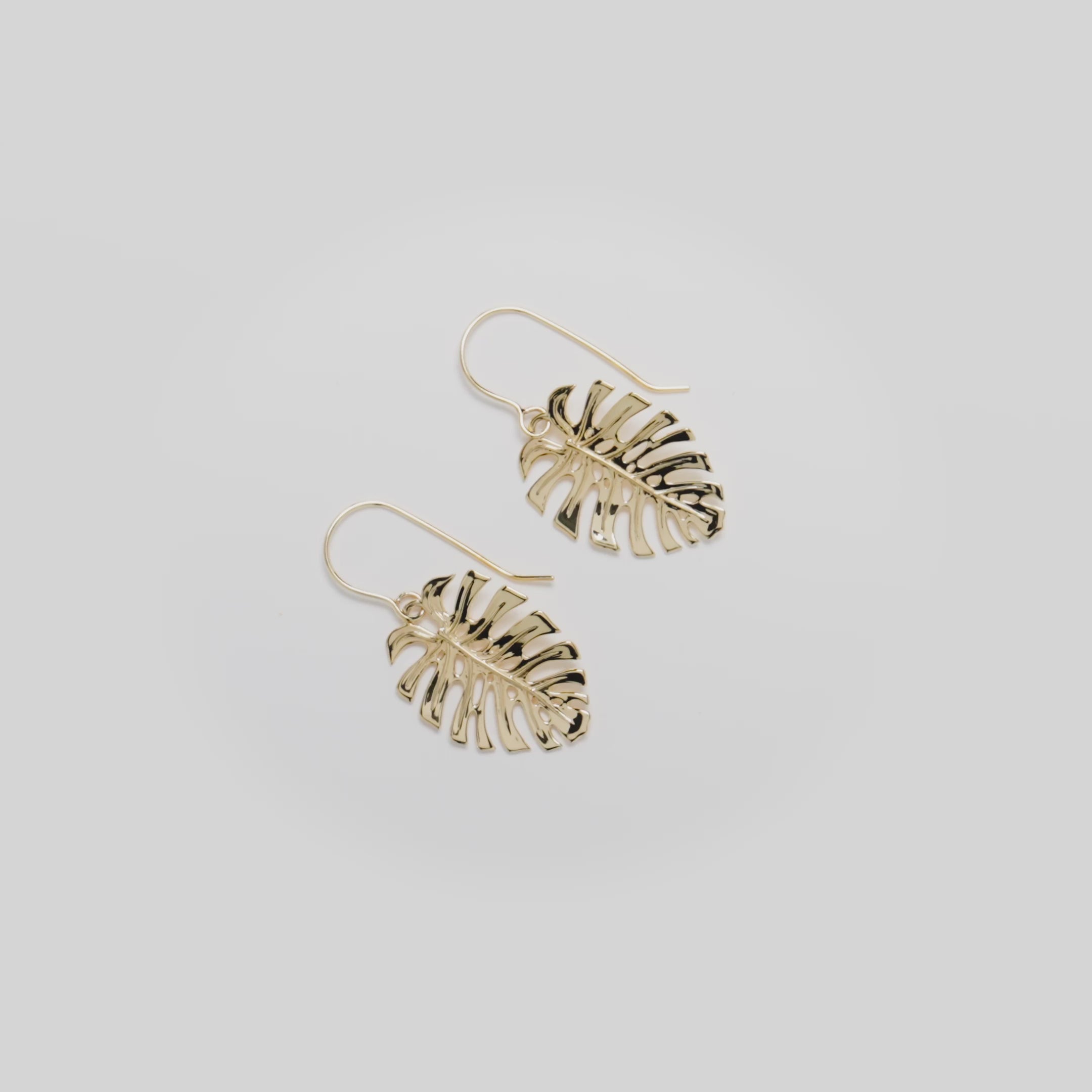 Video showcasing the 23mm Monstera Shepherd's Hook Earrings in 14k Yellow Gold