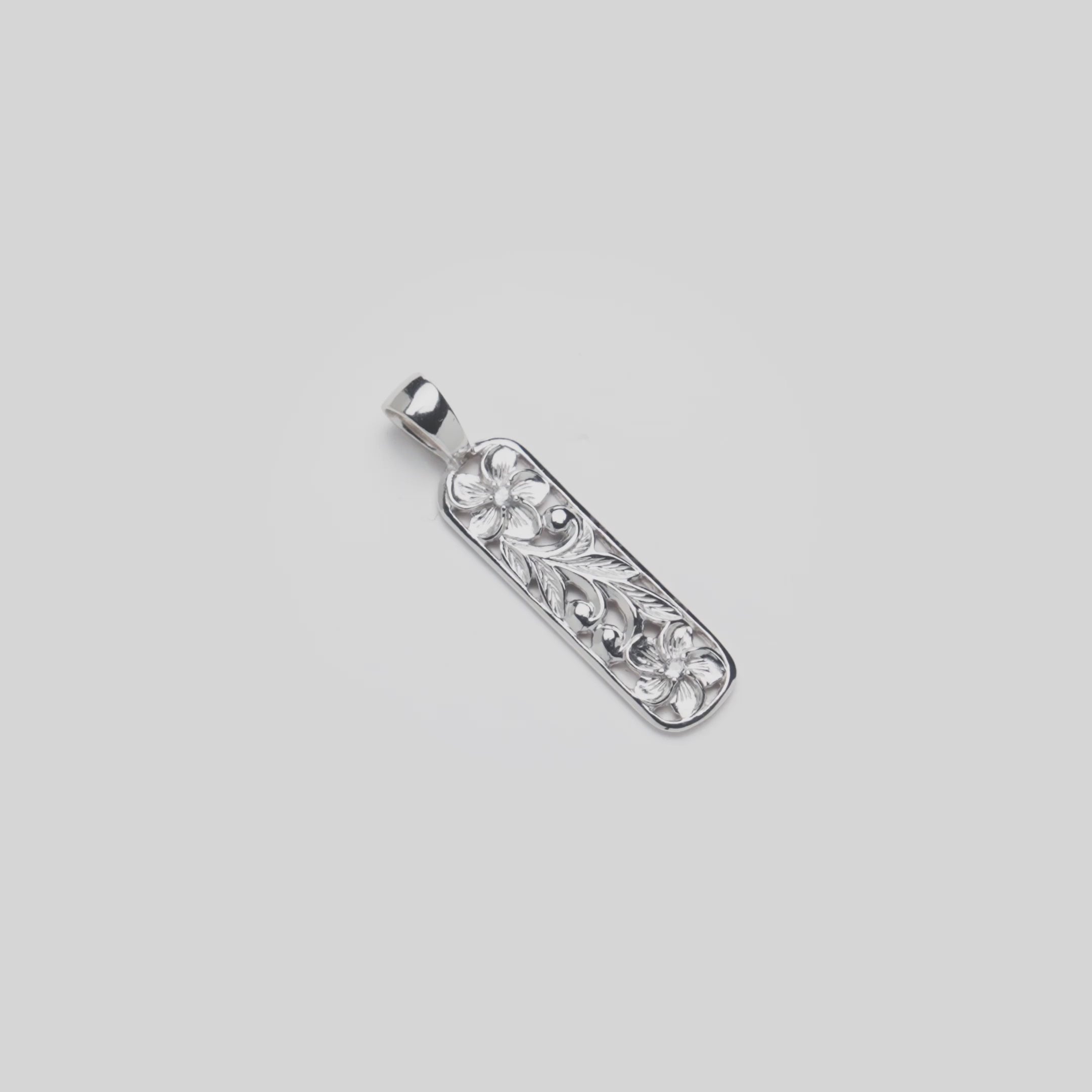 Video of the 32mm Hawaiian Heirloom Plumeria Pendant in Sterling Silver with White Sapphire turning on a white background