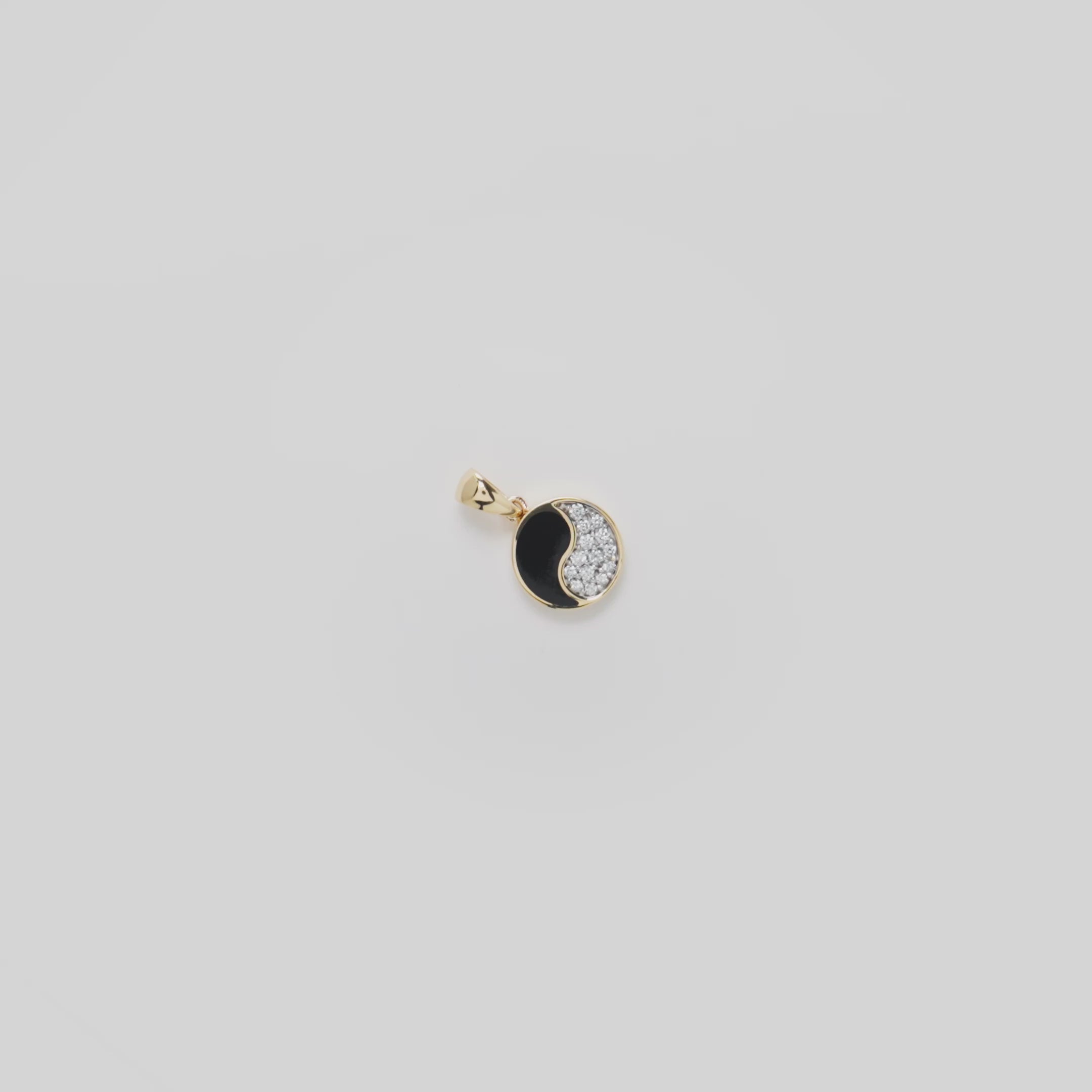 Video showcasing the 10mm Yin Yang Black Coral Pendant in 14k Yellow Gold with Diamonds on a turn table