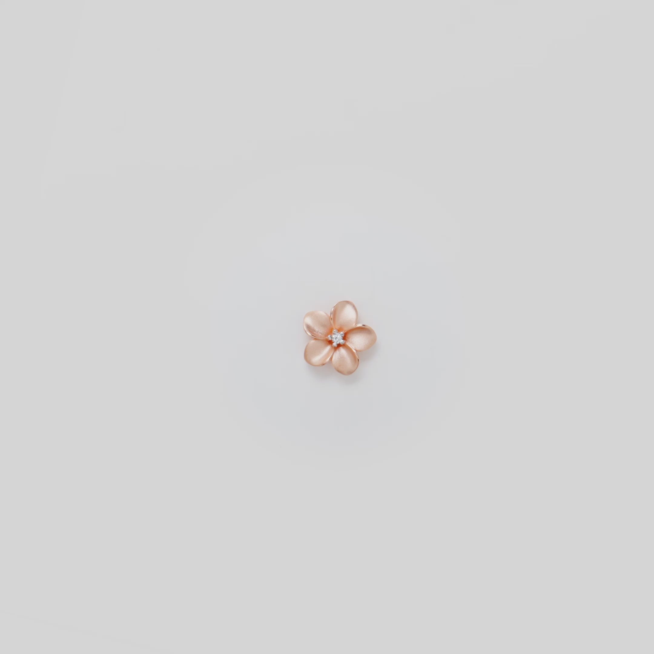 Video showcasing the 16mm Plumeria Pendant in 14k Rose Gold with Diamond on a turn table