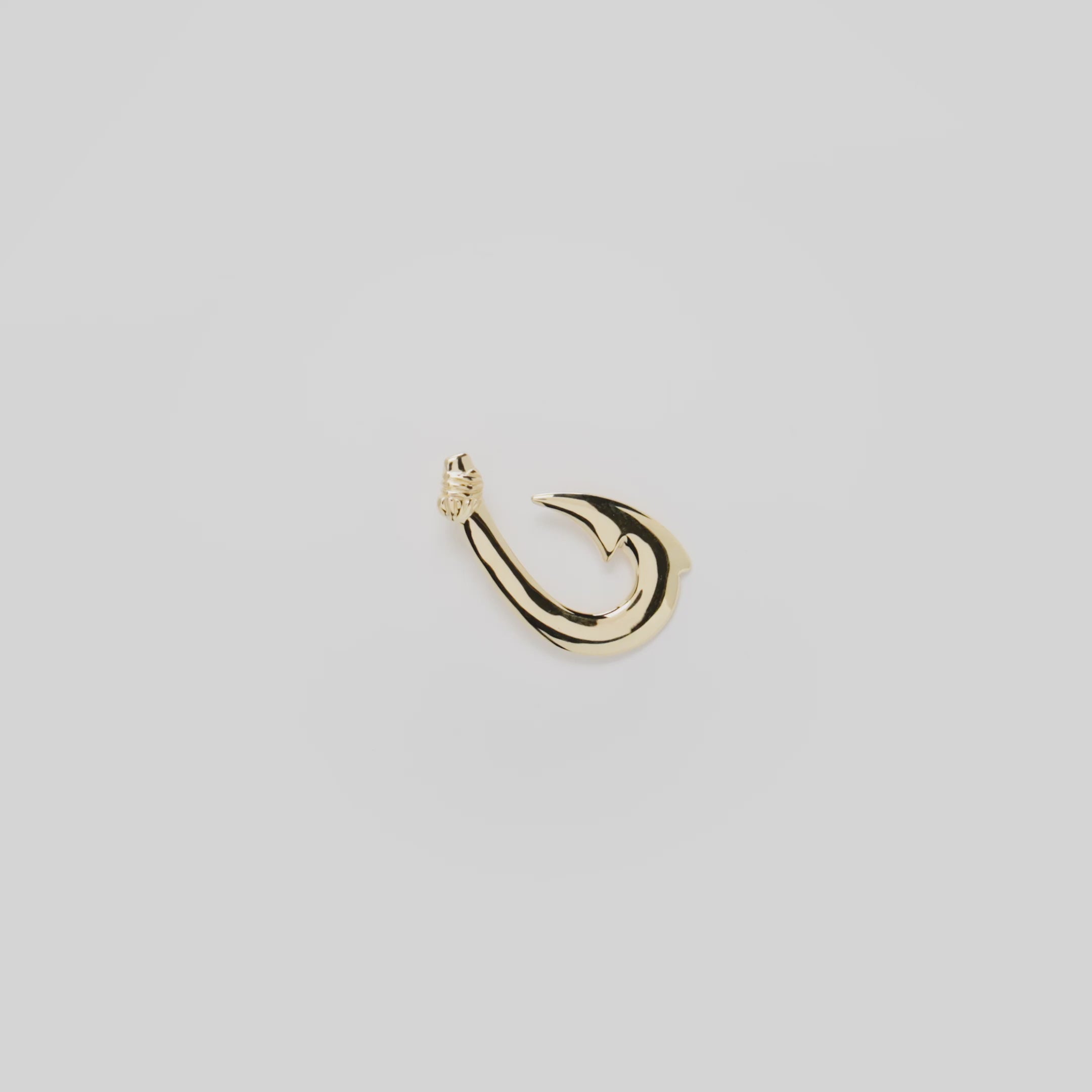 Video showcasing the 24mm Fish Hook Pendant in 14k Yellow Gold on a white background