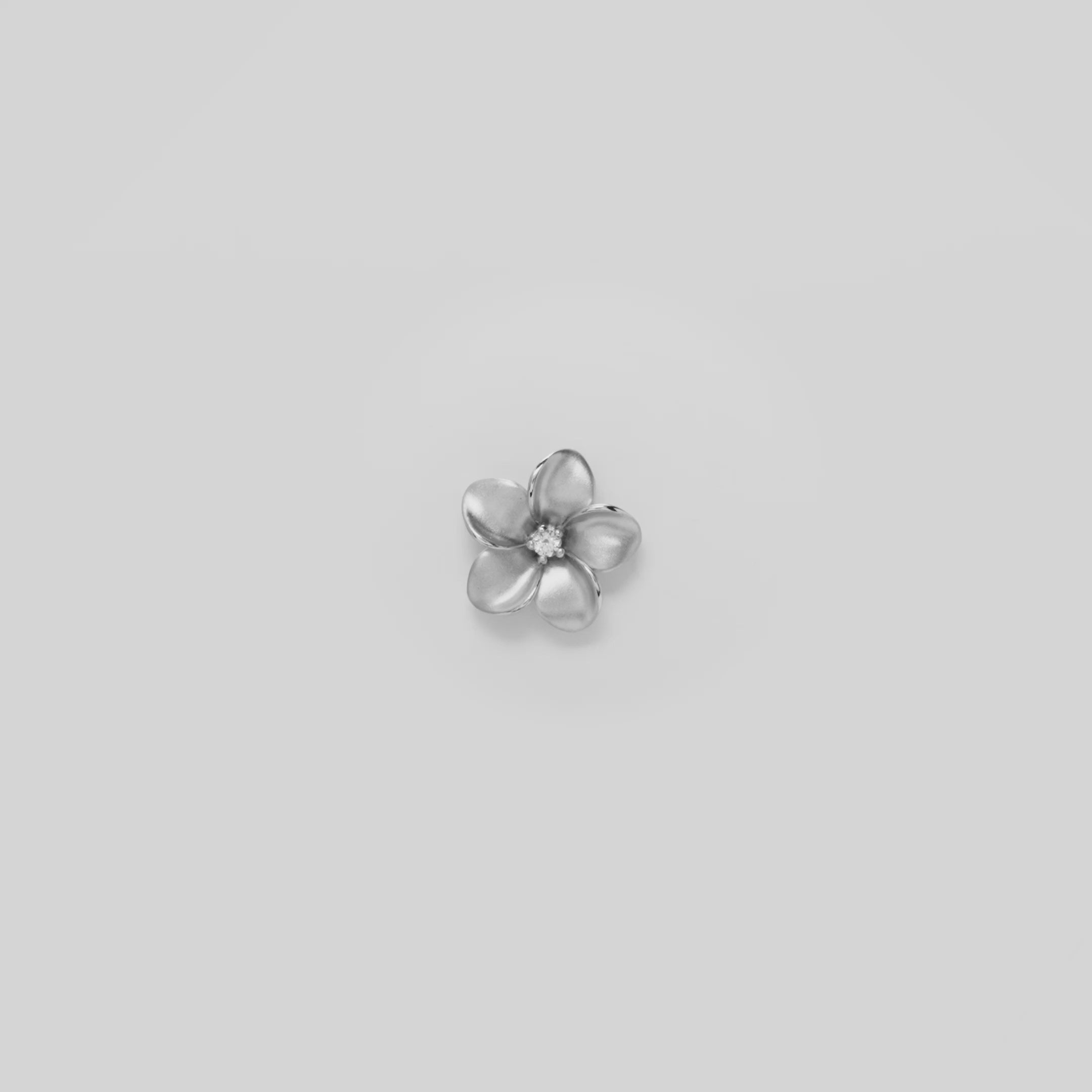 Video showcasing the 16mm Plumeria Pendant in 14k White Gold with Diamond on a white background