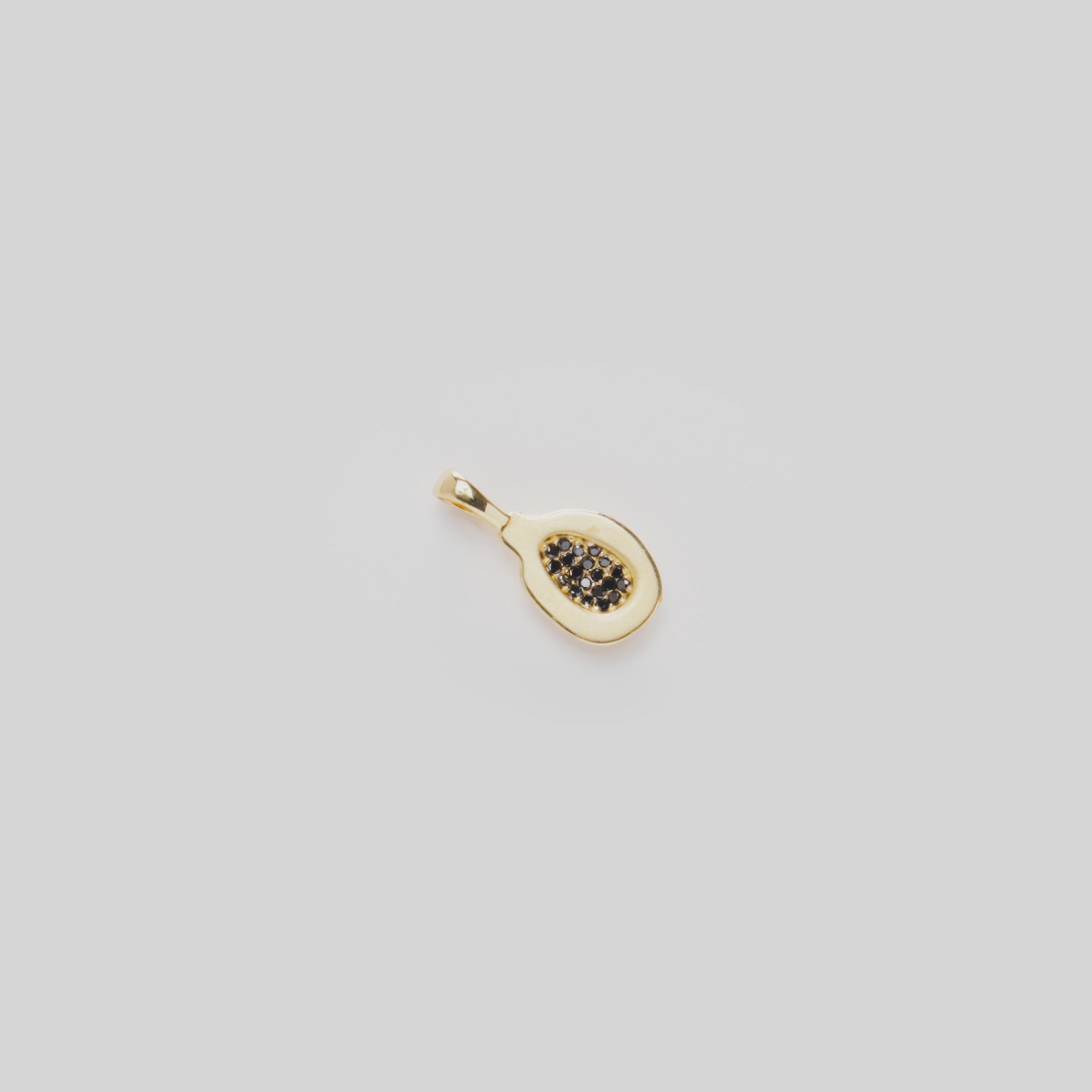 Close-up video of a Cute Fruits Papaya Pendant in 14k Yellow Gold with Black Diamonds rotating on a white background