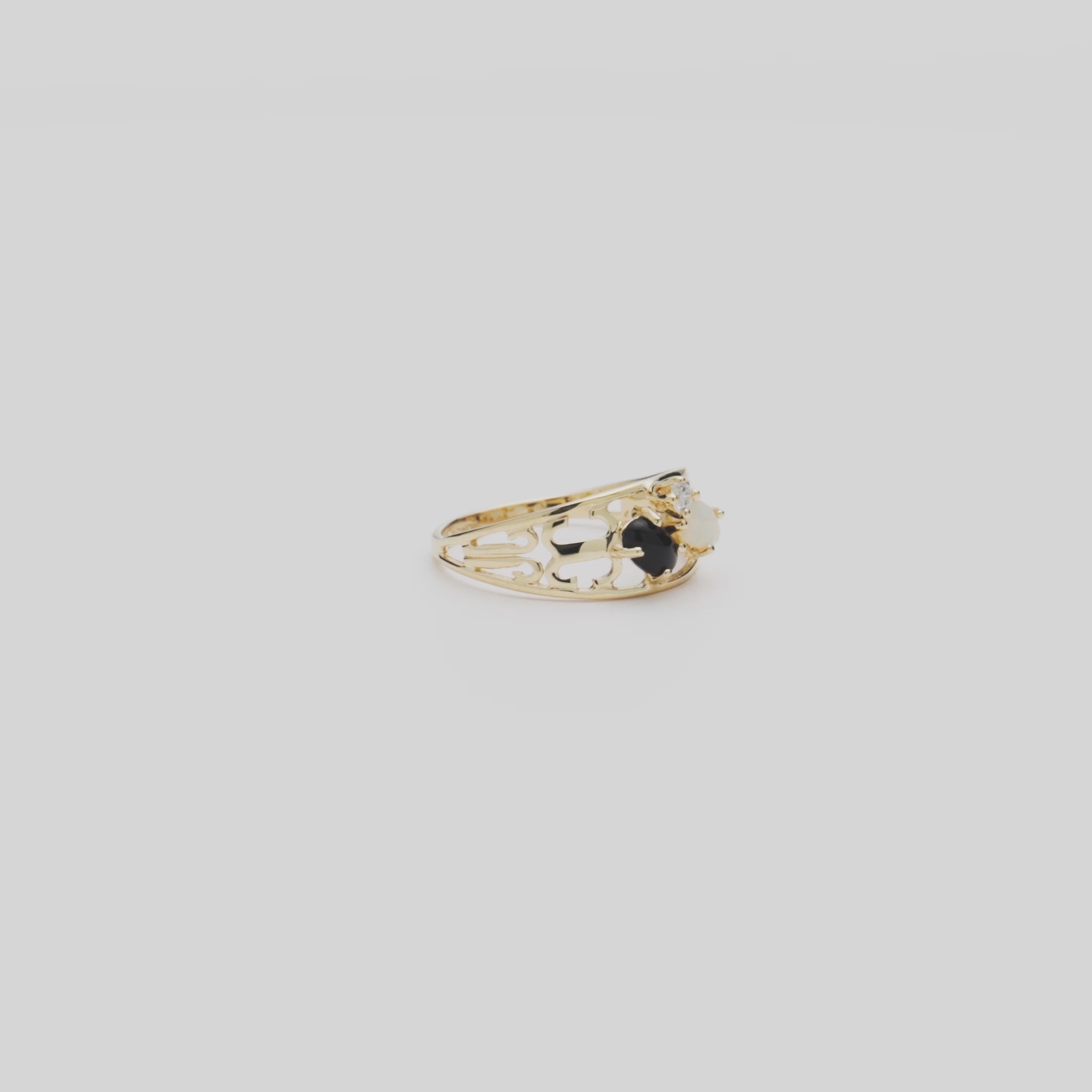 Video of the Black Coral Ring in Gold with Opal and Diamond turning on a white background