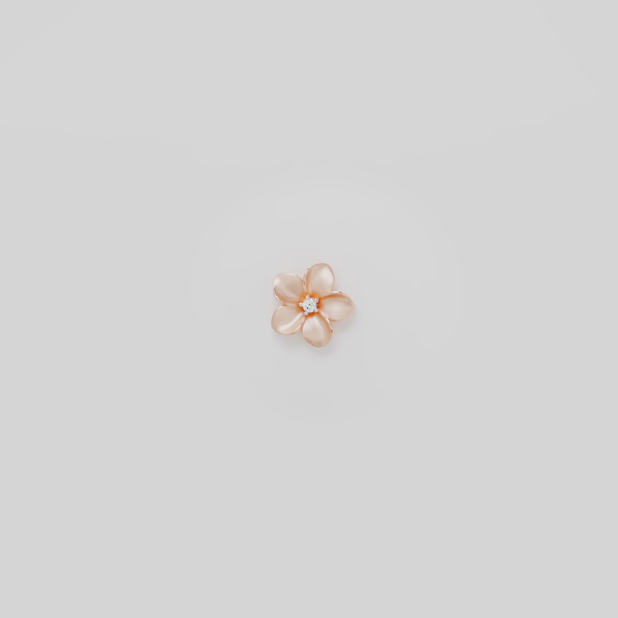 Video showcasing the 13mm Plumeria Pendant in 14k Rose Gold with Diamond on a turn table