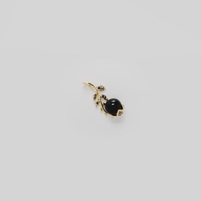 Video showcasing the Night Blossom Black Coral Pendant in 14k Yellow Gold with Black Diamonds on a turn table