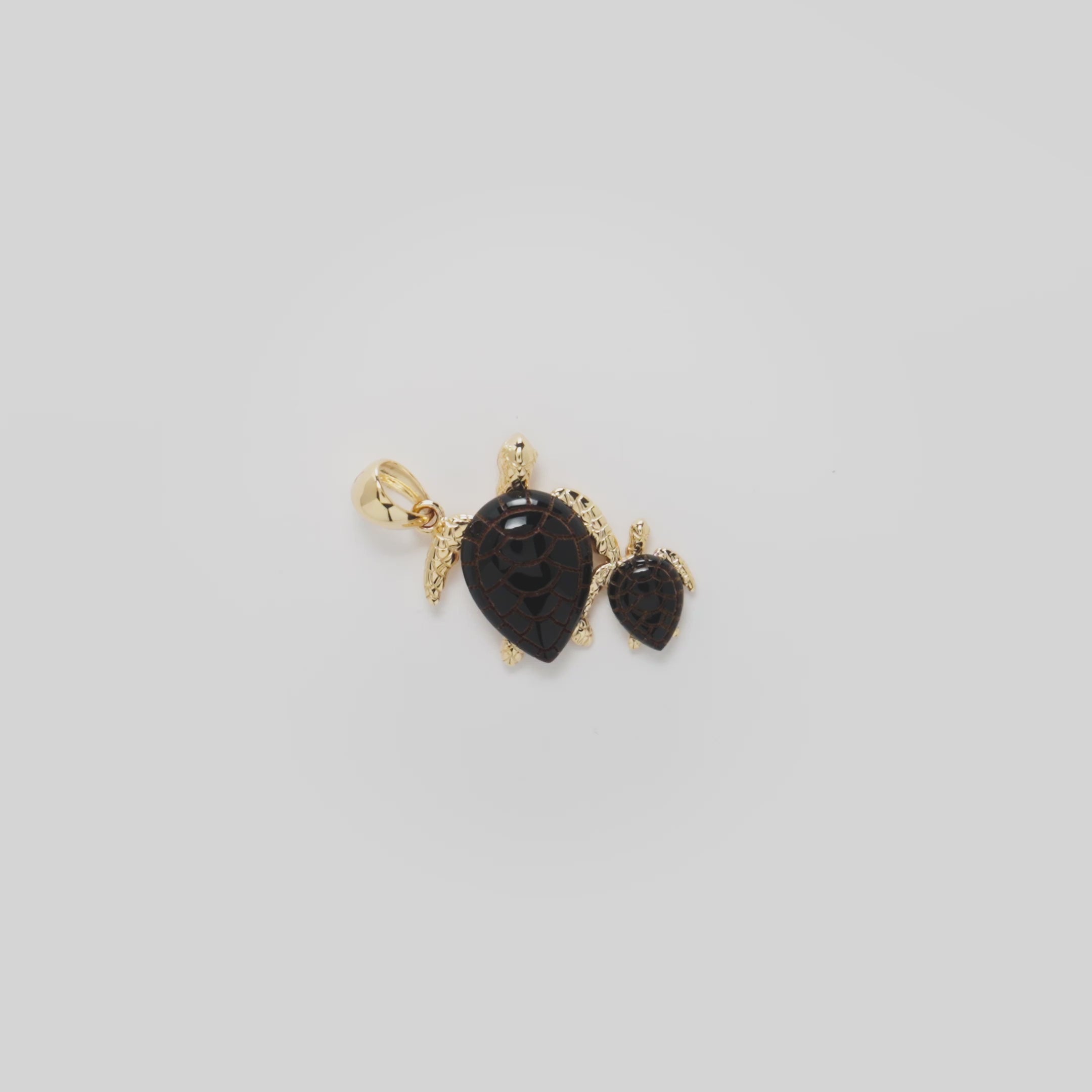Video showcasing the 22mm Honu Black Coral Pendant in 14k Yellow Gold on a white background