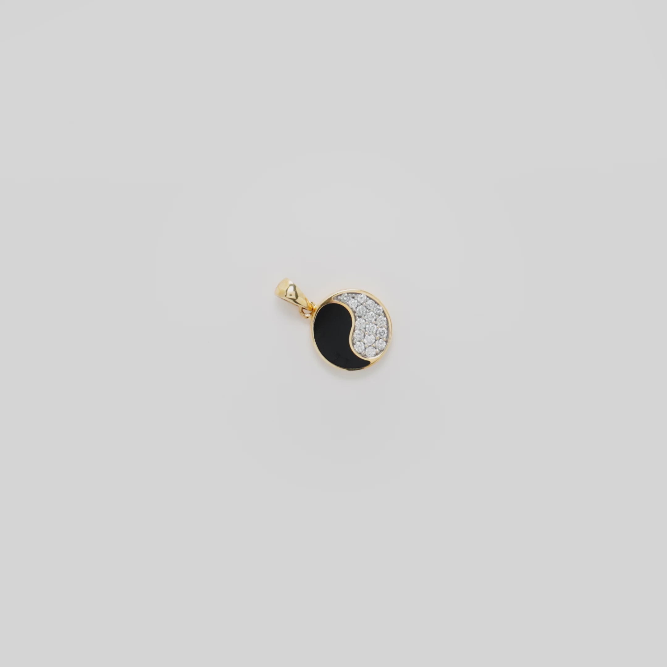 Video showcasing the 12mm Yin Yang Black Coral Pendant in 14k Yellow Gold with Diamonds on a turn table