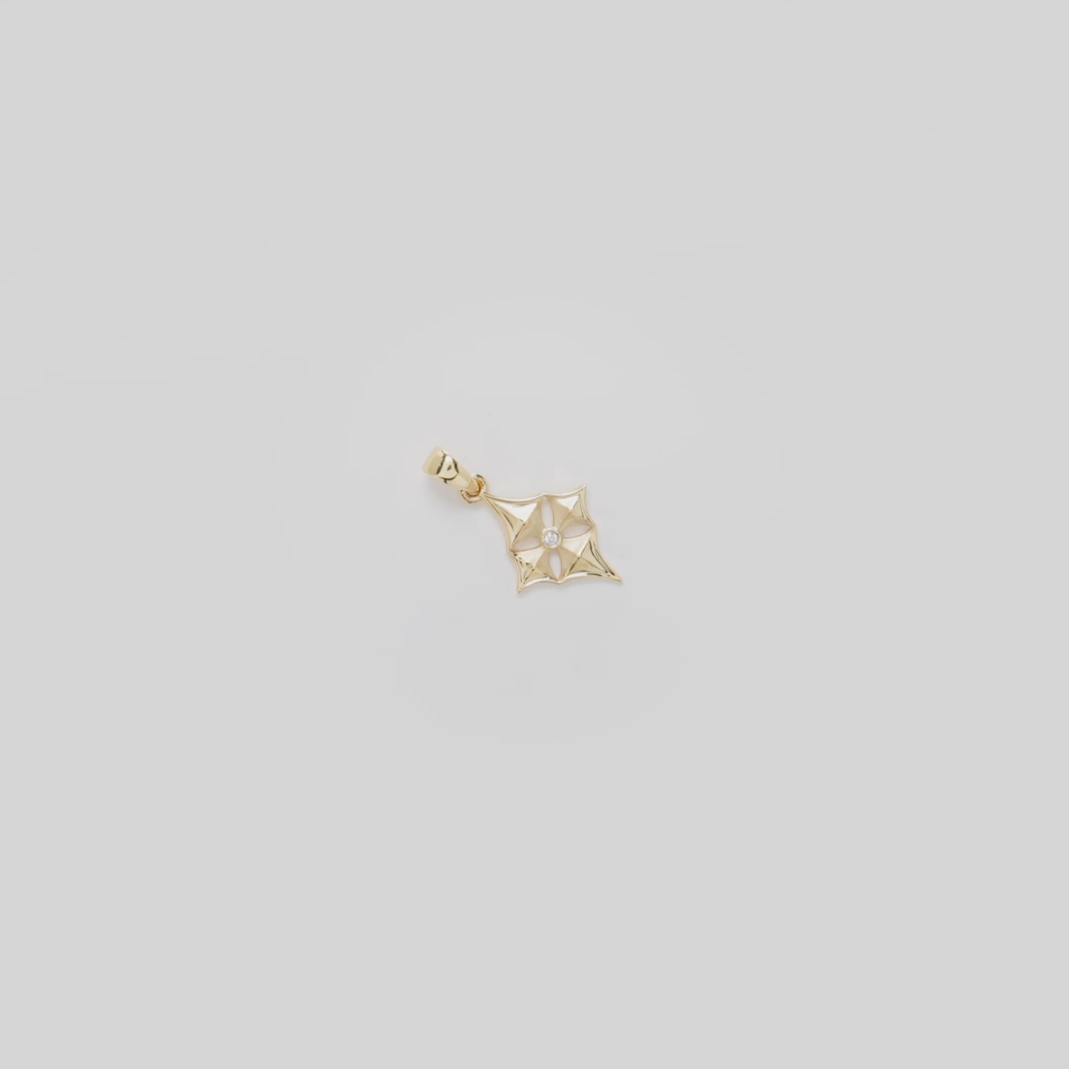 Video showcasing the 15mm Hawaiian Quilted Star Pendant in 14k Yellow Gold with Diamond on a white background