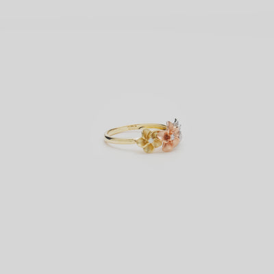 Video of the 8mm Plumeria Ring in Tri Color Gold with Diamonds turning on a white background