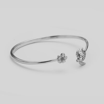 Video of the Honu and Plumeria Bracelet in Sterling Silver turning on a white background