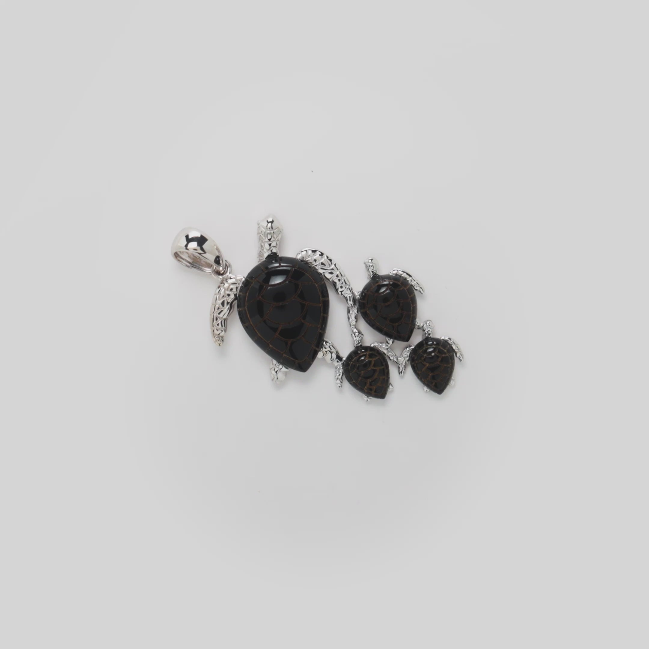 Video showcasing the 36mm Honu Black Coral Pendant in 14k white gold on a turn table