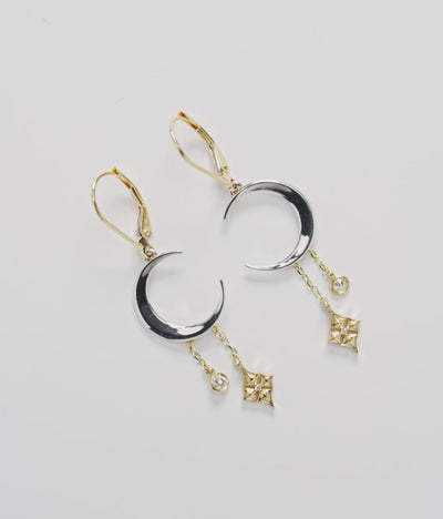 35mm Hawaiian Quilted Star and Moon Leverback Earrings in Two Tone Gold with Diamonds on a white turntable