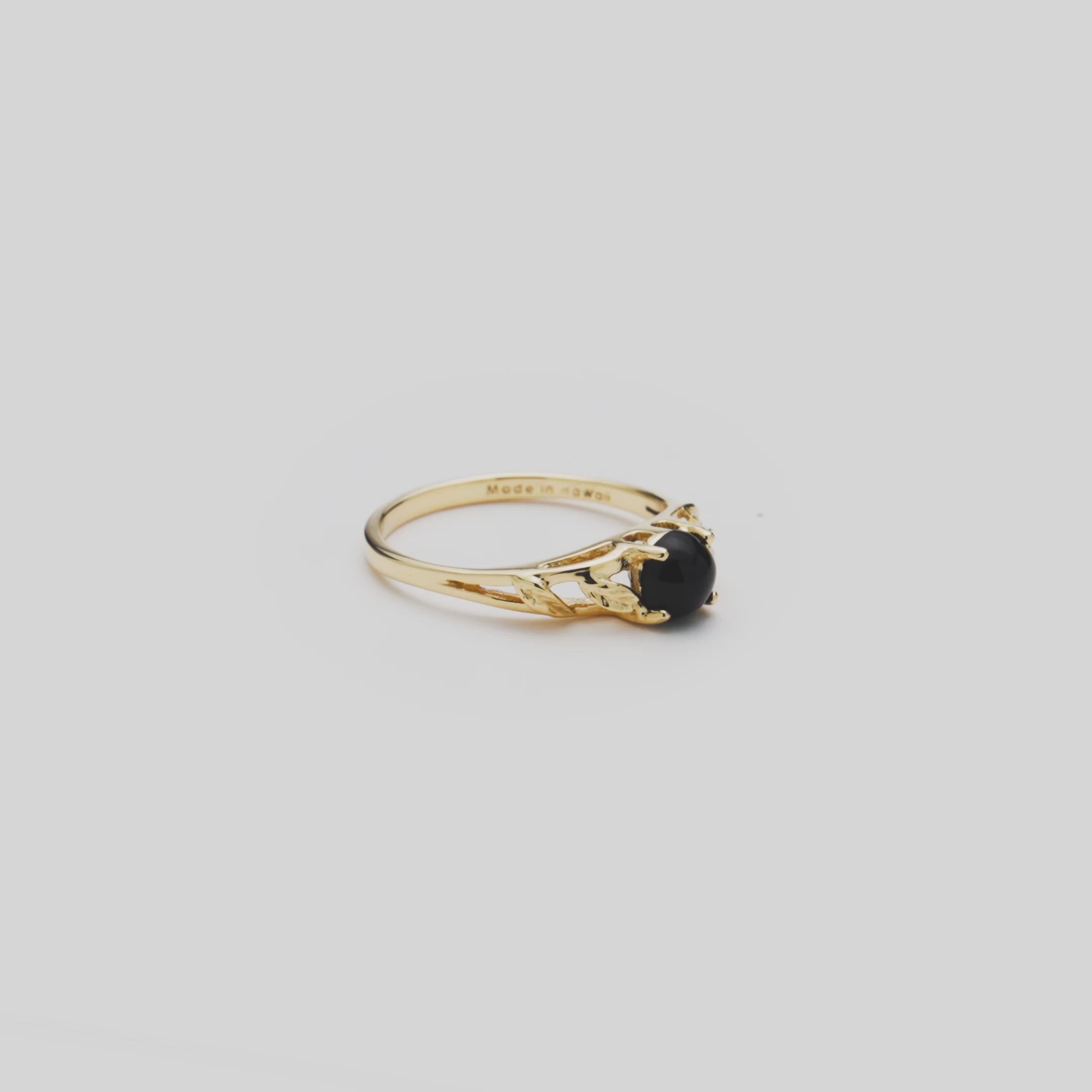 Video of the 5mm Maile Leaf Black Coral Ring in Gold turning on a white background