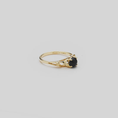 Video of the 5mm Maile Leaf Black Coral Ring in Gold turning on a white background