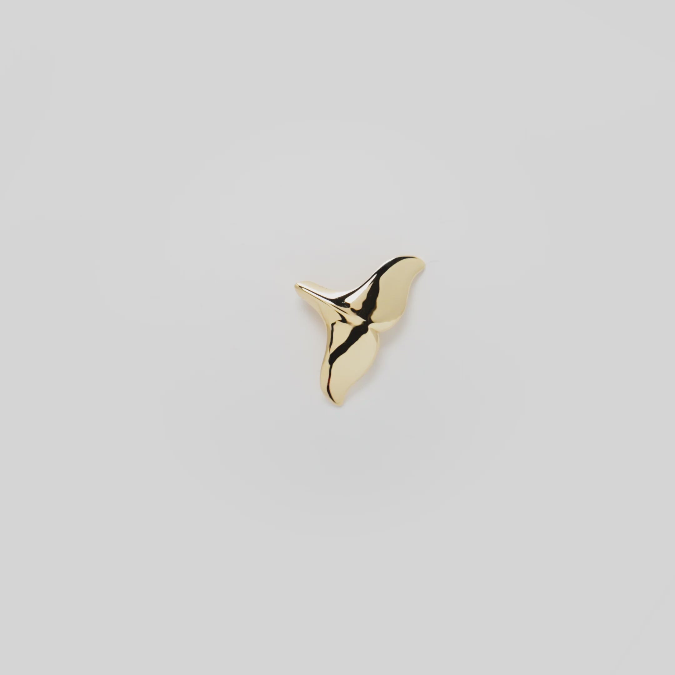 Video showcasing the 23mm Whale Tail Pendant in 14k Yellow Gold on a white background