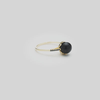 Video of the Night Blossom Black Coral Ring in Gold with Black Diamonds  turning on a white background