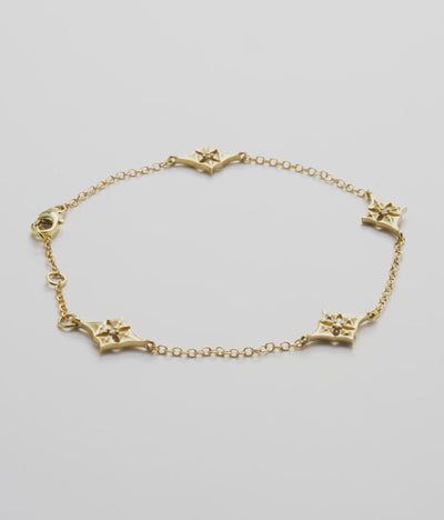 Video showcasing the Hawaiian Quilted Star Bracelet in 14k. Yellow Gold with Diamonds on a white turntable