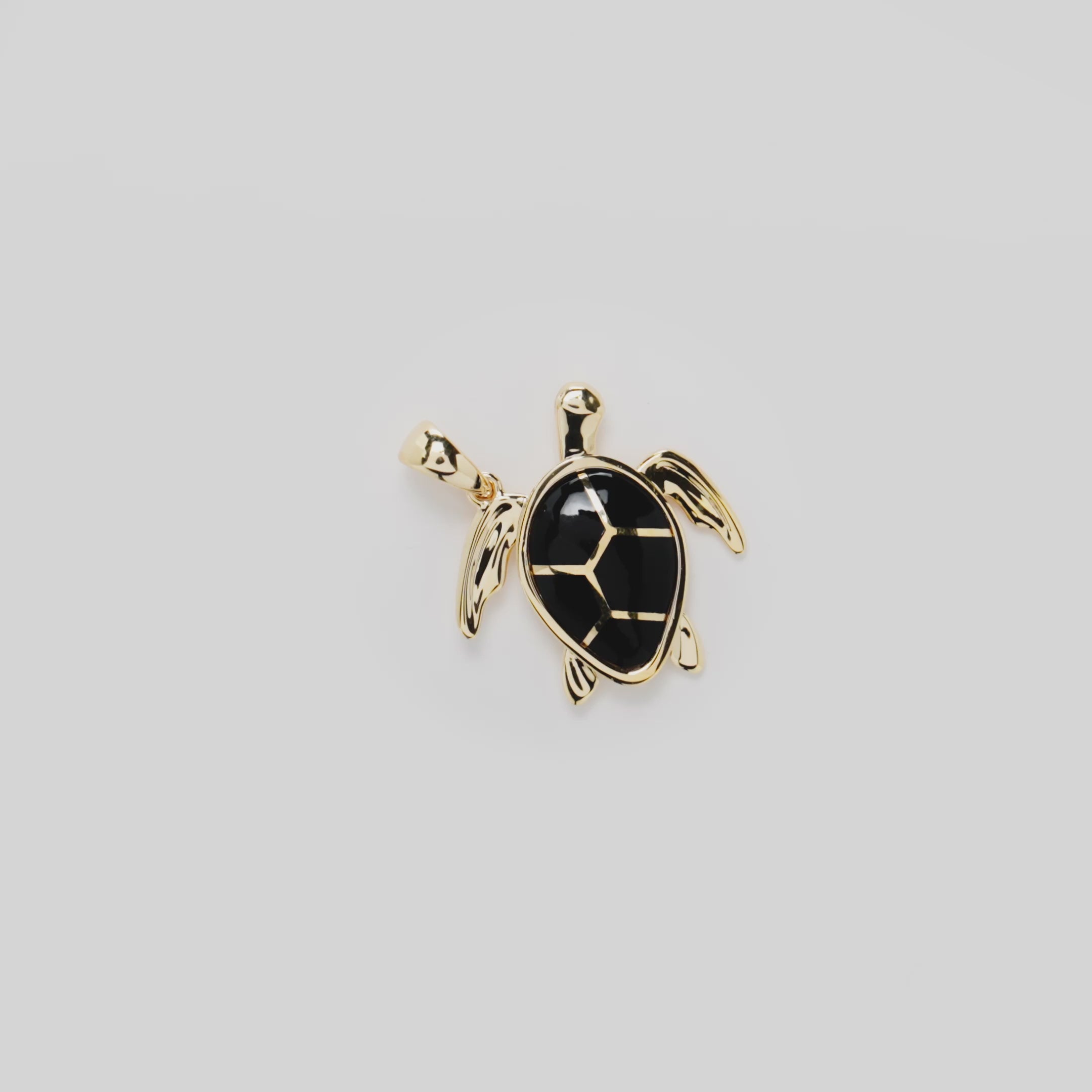 Video showcasing the Honu Black Coral Pendant in 14k Yellow Gold on a turn table
