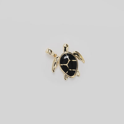 Video showcasing the Honu Black Coral Pendant in 14k Yellow Gold on a turn table
