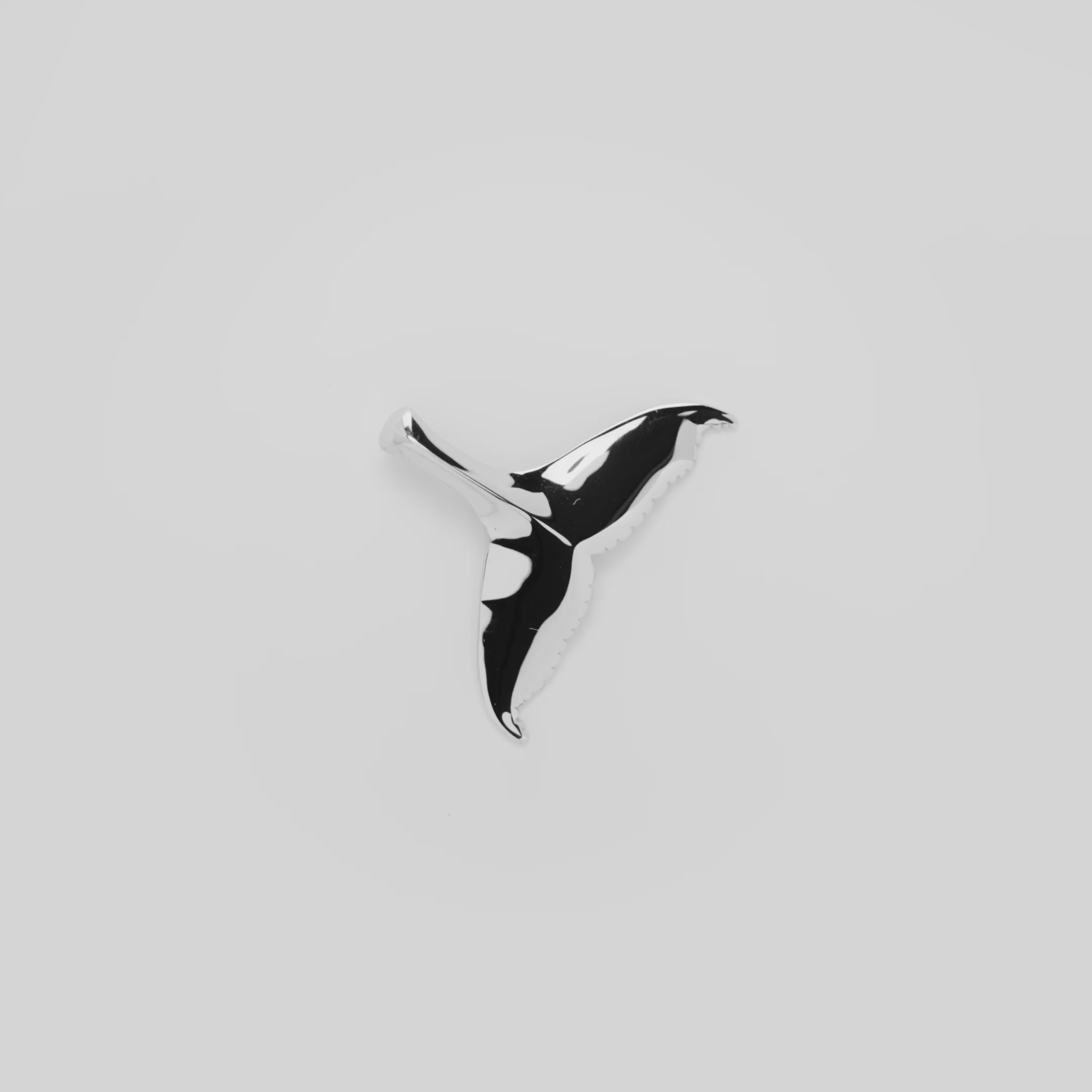 Video showcasing the 28mm Whale Tail Pendant in 14k White Gold on a turn table