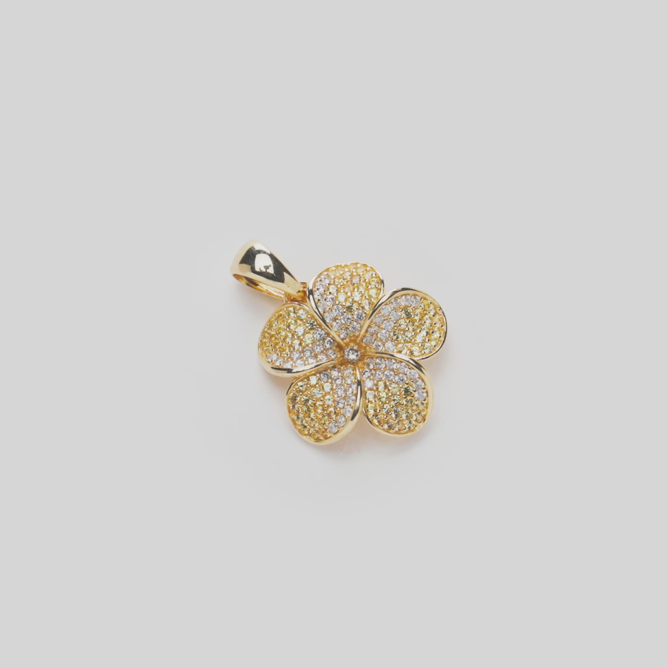 Plumeria Yellow Sapphire Pendant in Gold with Diamonds on a white turntable