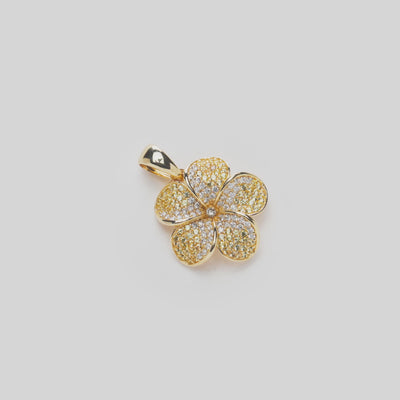 Plumeria Yellow Sapphire Pendant in Gold with Diamonds on a white turntable