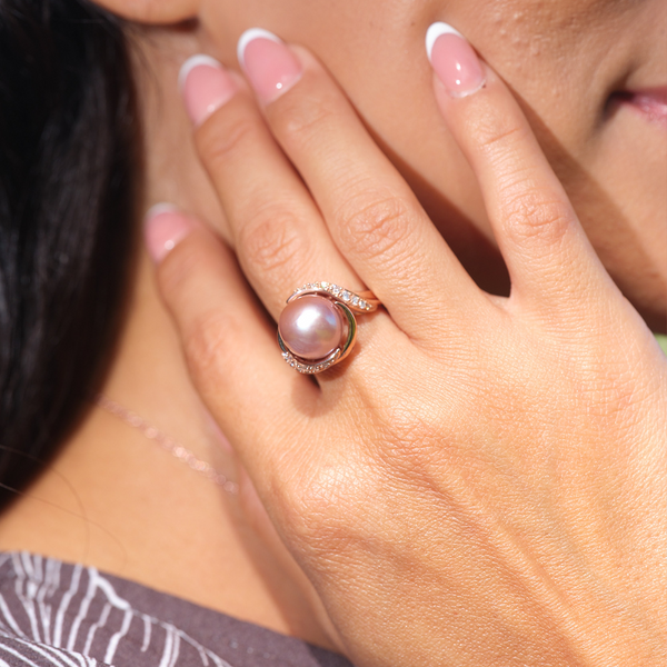 A woman's hand wearing a Lilac Freshwater Pearl Ring with Diamonds in Rose Gold (12-13mm)-Maui Divers Jewelry