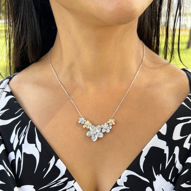 A woman wearing three different sizes of a Plumeria Pendant in White Gold with Diamond - 13mm-Maui Divers Jewelry
