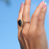 A woman's hand wearing a Princess Ka‘iulani Black Coral Ring in Gold with Diamonds-Maui Divers Jewelry