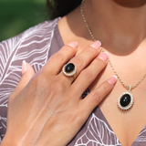 A woman wearing a Princess Ka‘iulani Black Coral Ring in Gold with Diamonds and a necklace -Maui Divers Jewelry