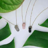 Black Coral, Black Mother of Pearl and Pink Coral Slippers Pendant in Gold next to leaves - Maui Divers Jewelry