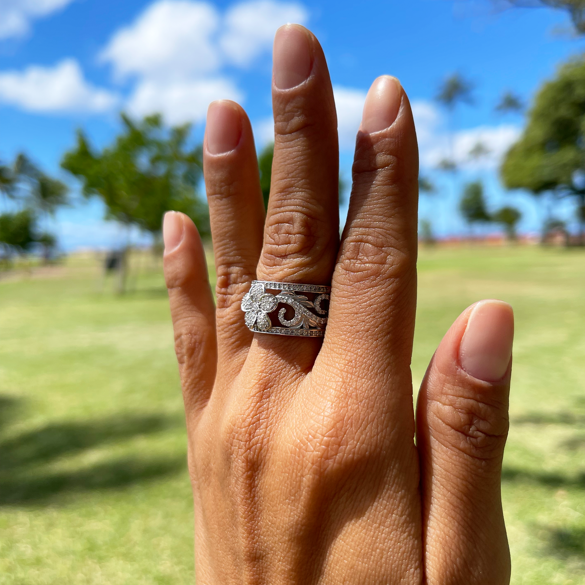 A woman's hand with a Hawaiian Heirloom Engagement Ring in White Gold with Diamonds - 12mm-Maui Divers Jewelry
