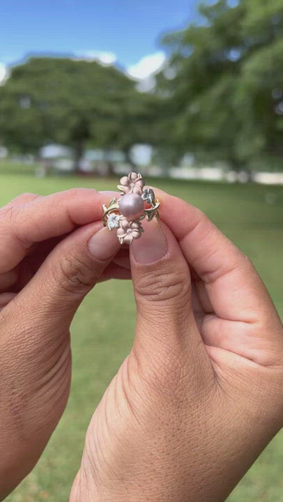 Video of a woman's hand wearing a Pearls in Bloom Plumeria Lavender Freshwater Pearl Ring in Tri Color Gold with Diamonds - 22mm - Maui Divers Jewelry