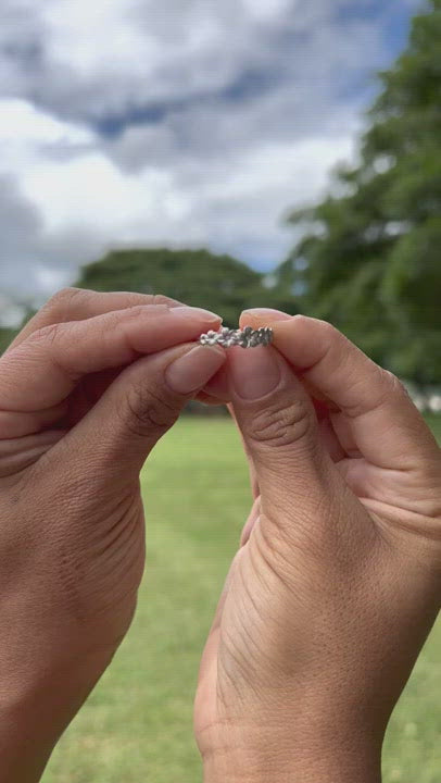Video of a woman's hand with a Plumeria Ring in White Gold with Diamonds on it - Maui Divers Jewelry