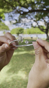 Video of a woman's hand wearing a Honu and Plumeria Bracelet and a Ring in Sterling Silver - Maui Divers Jewelry