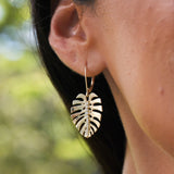 A woman's ear with Monstera Earrings in Gold with Diamonds - 23mm - Maui Divers Jewelry